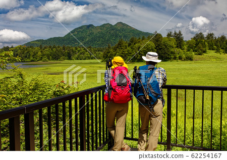 Hiker looking at Hiuchigatake from Ozenuma Hiker looking at Hiuchigatake from Ozenuma 62254167