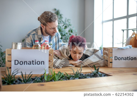 Sad young girl in plaid sitting at the table. Sad young girl in plaid sitting at the table. 62254302