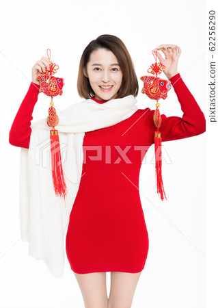pretty girl holding chinese new year decoration pretty girl holding chinese new year decoration 62256290
