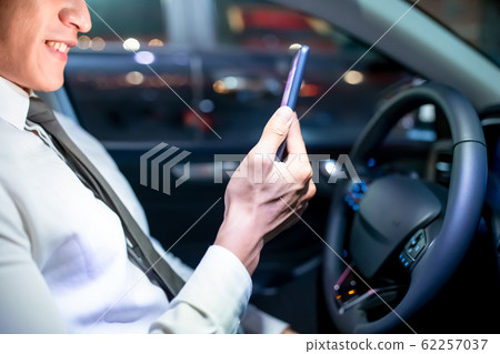 businessman use smartphone in car 62257037
