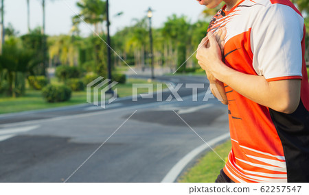 Sport man having heart attack or chest pain after running workout at park. Sport, healthcare concept Sport man having heart attack or chest pain after running workout at park. Sport, healthcare concept 62257547