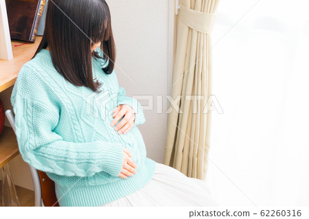 Pregnant woman checking fetal movement 62260316