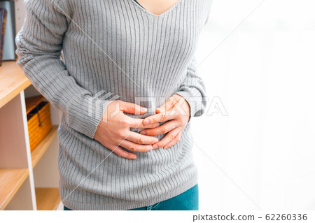 A woman with abdominal pain Various symptoms such as illness and stress 62260336