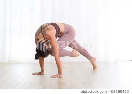 Portrait of gorgeous active sporty young woman practicing yoga in studio. Beautiful girl practice Sasangasana, rabbit yoga pose. Healthy active lifestyle, working out indoors in gym Portrait of gorgeous active sporty young woman practicing yoga in studio. Beautiful girl practice Sasangasana, rabbit yoga pose. Healthy active lifestyle, working out indoors in gym 62260433