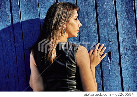 Portrait of a young slim woman brunette in a black Portrait of a young slim woman brunette in a black 62260594