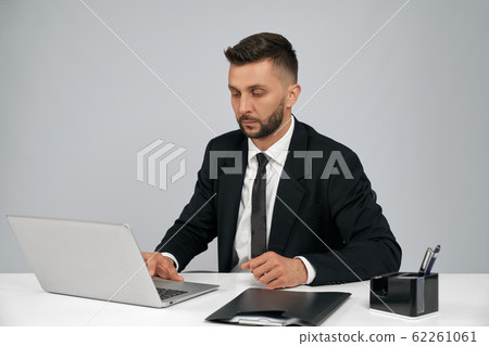 Young businessman working on laptop. 62261061