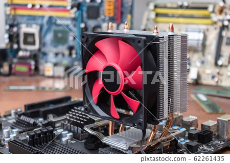 A broken motherboard cooling system due to dust is under repair in a computer workshop A broken motherboard cooling system due to dust is under repair in a computer workshop 62261435