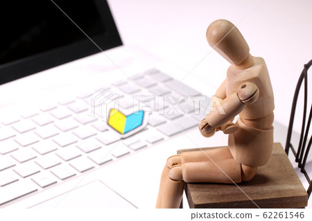 Beginner mark with laptop computer and wooden doll 62261546