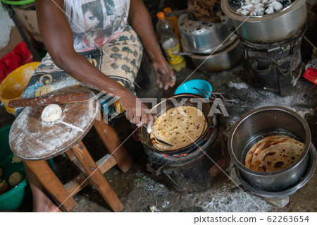 Basic African kitchen. Cooking on the fire Chapati - local food Basic African kitchen. Cooking on the fire Chapati - local food 62263654
