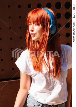 Young woman moves in dance on sunny street alone Young woman moves in dance on sunny street alone 62263835