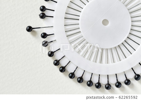 White needle bed with black pins over white 62265592
