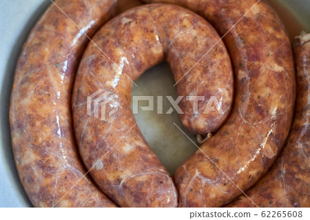 Raw handmade sausages. Selective focus, closeup. 62265608