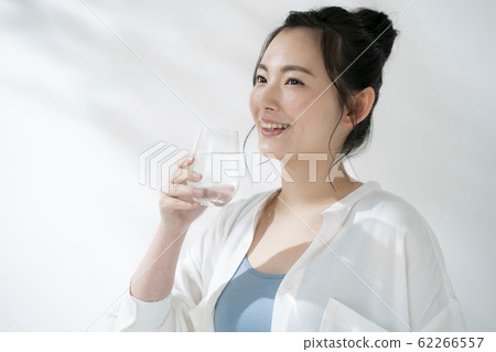 Young woman drinking water Young woman drinking water 62266557