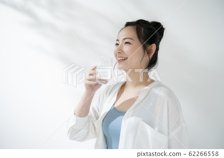 Young woman drinking water Young woman drinking water 62266558