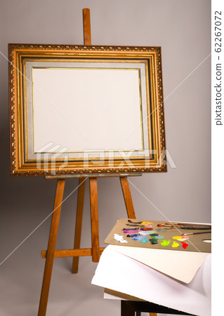 Oil painting. Easel and blank canvas. Palette Stock Photo