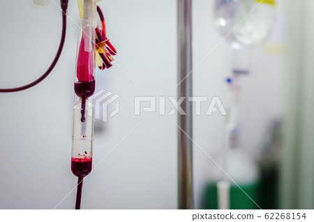 Closeup Blood transfusion intravenous to a patient in the hospital hand held shooting Closeup Blood transfusion intravenous to a patient in the hospital hand held shooting 62268154