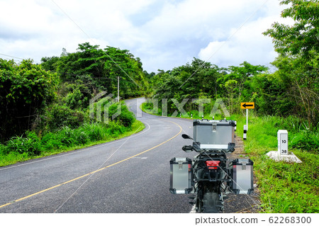 Back view of touring motorbike with aluminum box for contain baggage are stop on roadside before travel to countryside trip 62268300