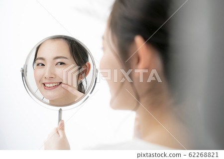Woman checking skin condition 62268821