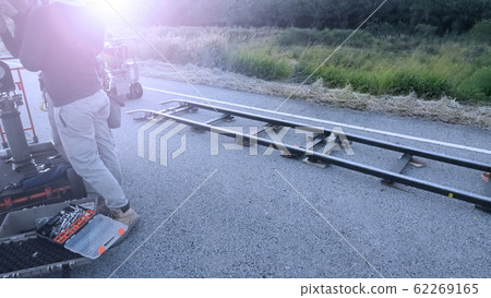 Video production camera dolly track at outdoor location setting for shooting movie or film that need smooth and dynamic stable tracking while moving frame shot which made for professional work Video production camera dolly track at outdoor location setting for shooting movie or film that need smooth and dynamic stable tracking while moving frame shot which made for professional work 62269165