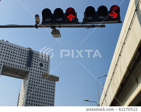 BANGKOK, THAILAND- September 5, 2019: The view from the bottom to the elephant building, the traffic lights are showing the red light, the bridge over the road and the background is clear sky. BANGKOK, THAILAND- September 5, 2019: The view from the bottom to the elephant building, the traffic lights are showing the red light, the bridge over the road and the background is clear sky. 62270522