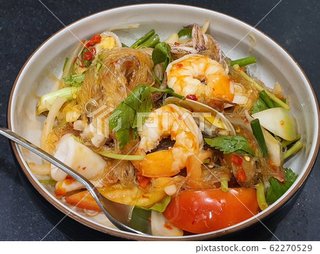 Traditional Thai spicy Noodle vermicelli with seafood shrimp, squid and Thai herb. Traditional Thai spicy Noodle vermicelli with seafood shrimp, squid and Thai herb. 62270529