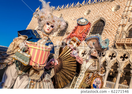 Colorful carnival masks against Doges palace at a traditional festival in Venice, Italy 62271546
