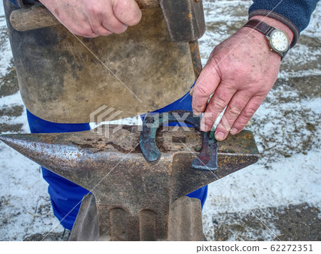 Detail of making new horseshoe in blacksmith Detail of making new horseshoe in blacksmith 62272351