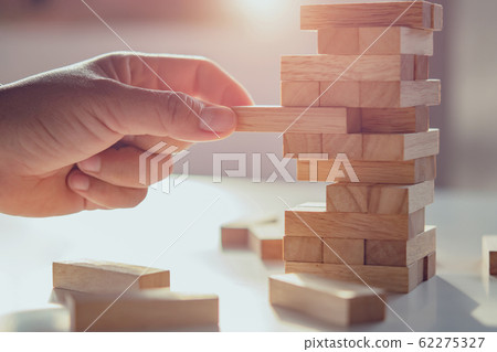close up of hand playing block wood with sunshine close up of hand playing block wood with sunshine 62275327