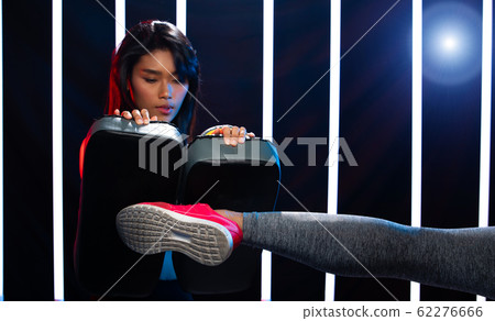 Girl exercises in Modern Neon Boxing Gym heavily Girl exercises in Modern Neon Boxing Gym heavily 62276666