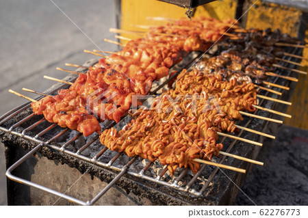 Chicken satay skewer on bbq coal grill. 62276773