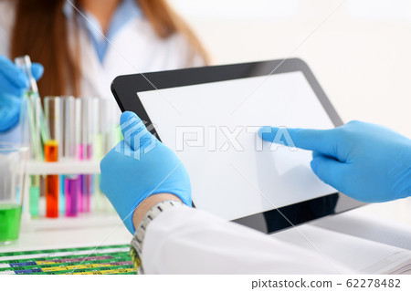 Male technician arms in protective gloves hold tablet Male technician arms in protective gloves hold tablet 62278482
