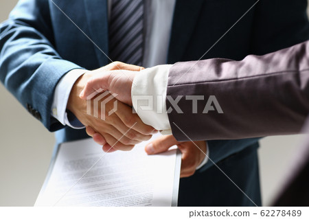 Man in suit shake hand as hello in office closeup 62278489