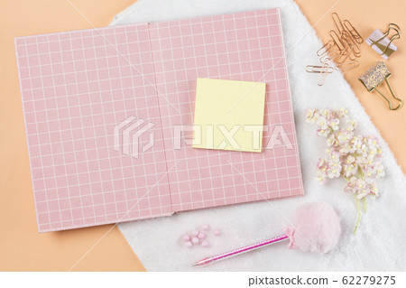 flat lay stationery on work desk in orange pastel background 62279275