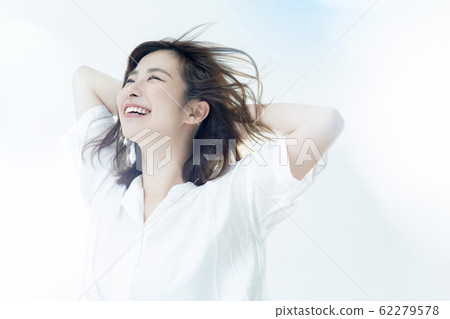 A woman blowing in the wind 62279578