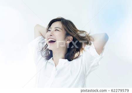 A woman blowing in the wind 62279579