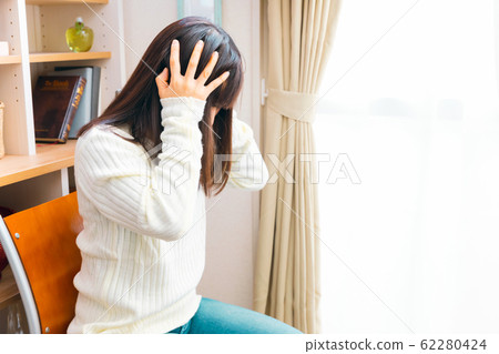 Woman holding head worries headache regret neuroses depression 62280424