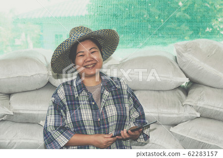 Smart farmer agriculturist with Organic Fertilizer Smart farmer agriculturist with Organic Fertilizer 62283157