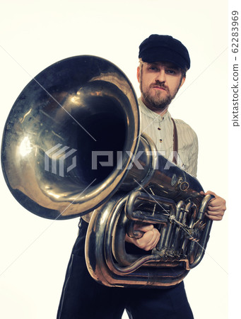 man with suspenders and cap holding the tube 62283969