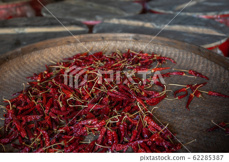 Chili drying in a wicker bowl Chili drying in a wicker bowl 62285387