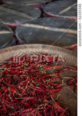 Chili drying in a wicker bowl 62285388