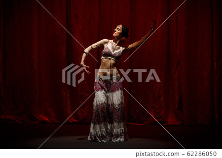 Dancer dancing belly dance on a concert stage. Dancer dancing belly dance on a concert stage. 62286050