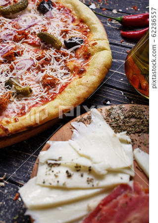 Traditional Italian pizza on a dark table with Traditional Italian pizza on a dark table with 62286557