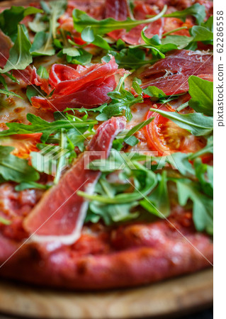 Macro food background. Pizza with meat and arugula Macro food background. Pizza with meat and arugula 62286558