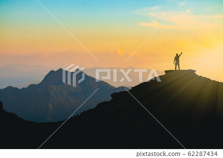 The silhouette of a man with a cheerful raise in The silhouette of a man with a cheerful raise in 62287434