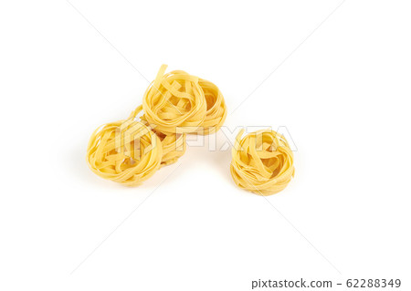 nest of tagliatelle pasta isolated on white background. nest of tagliatelle pasta isolated on white background. 62288349