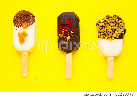 Sweet popsicles on yellow background. Mini dessert Sweet popsicles on yellow background. Mini dessert 62289378
