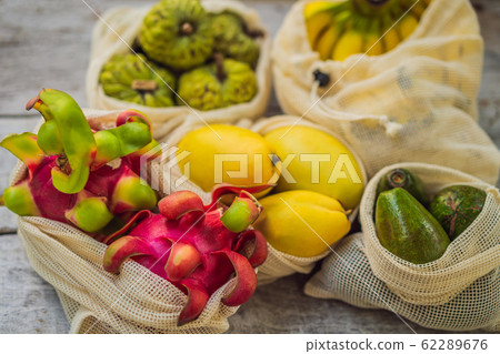 Fruit in a reusable bag on a stylish wooden kitchen surface. Zero waste concept, plastic free 62289676