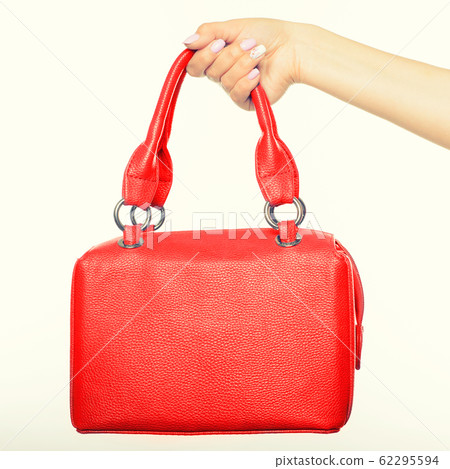 female hand holding red bag isolated female hand holding red bag isolated 62295594