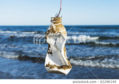used plastic bottle in a fish hook. used plastic bottle in a fish hook. 62296149