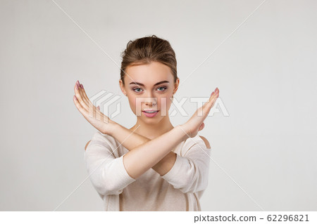 beautiful young woman making stop gesture 62296821